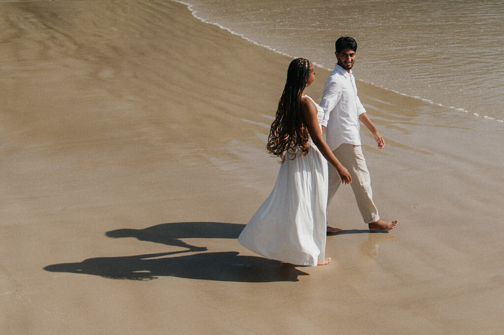 A playful moment as the couple poses on a quiet morning at Maracas Beach
