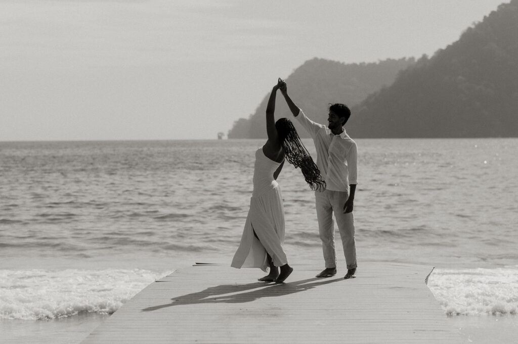 A playful moment as the couple poses on a quiet morning at Maracas Beach
