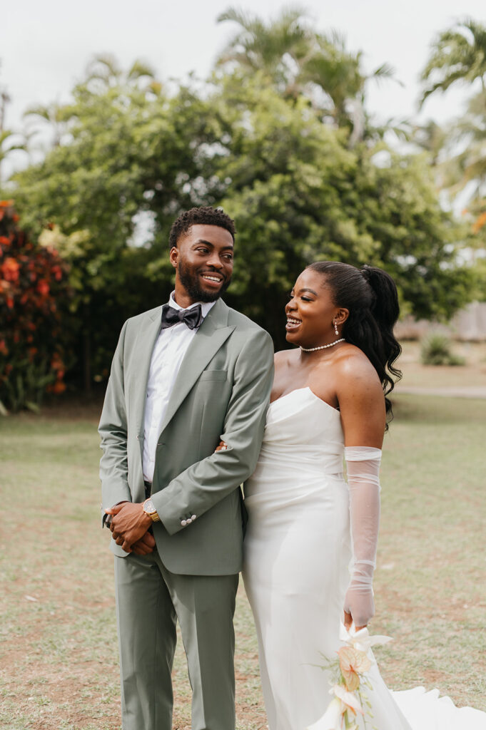 Wedding ceremony setup on the beach with tropical floral decor and ocean views
