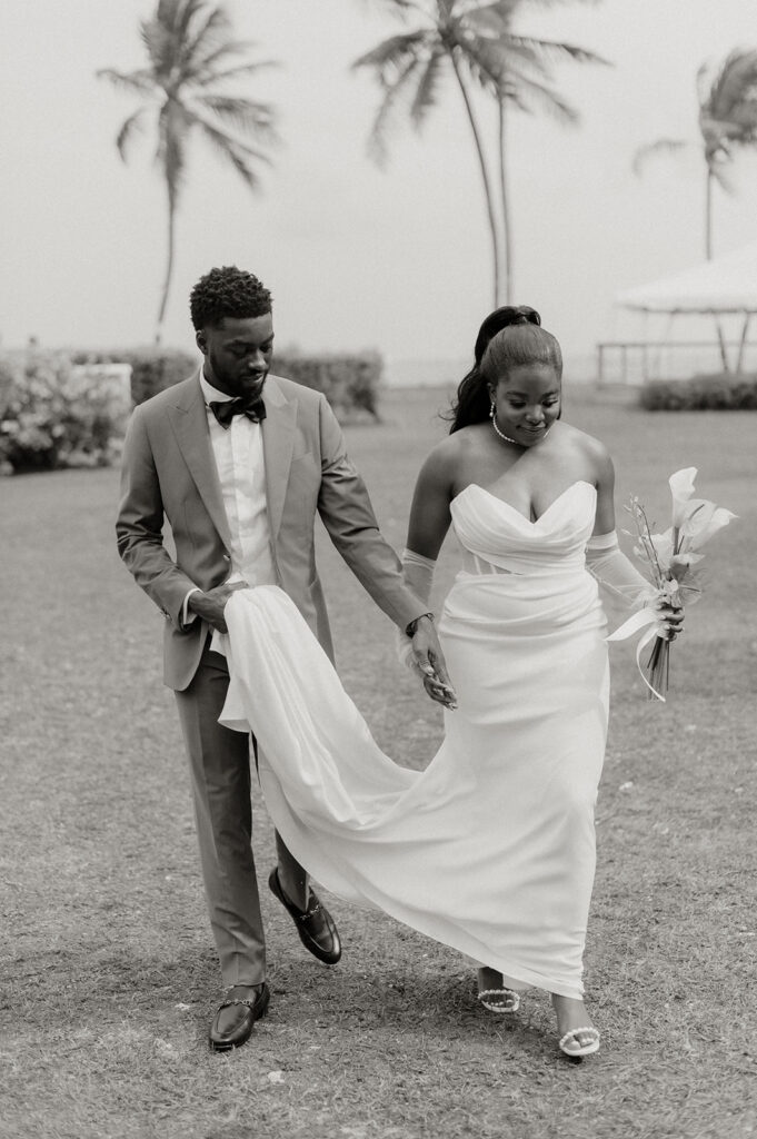 Wedding ceremony setup on the beach with tropical floral decor and ocean views
