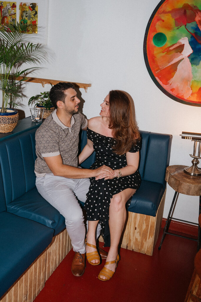 Couple enjoying cocktails together during their engagement session on Ariapita Avenue
