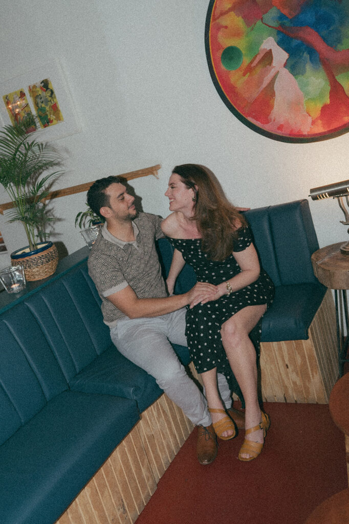 Couple enjoying cocktails together during their engagement session on Ariapita Avenue
