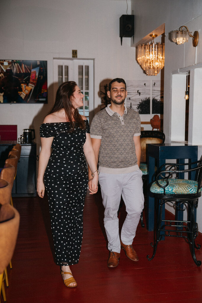 Couple enjoying cocktails together during their engagement session on Ariapita Avenue
