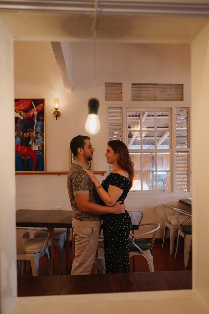 Candid flash photo of a couple dancing at a bar
