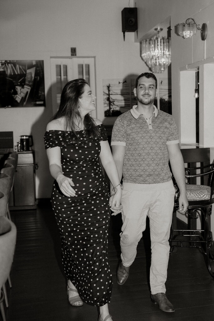 Couple enjoying cocktails together during their engagement session on Ariapita Avenue
