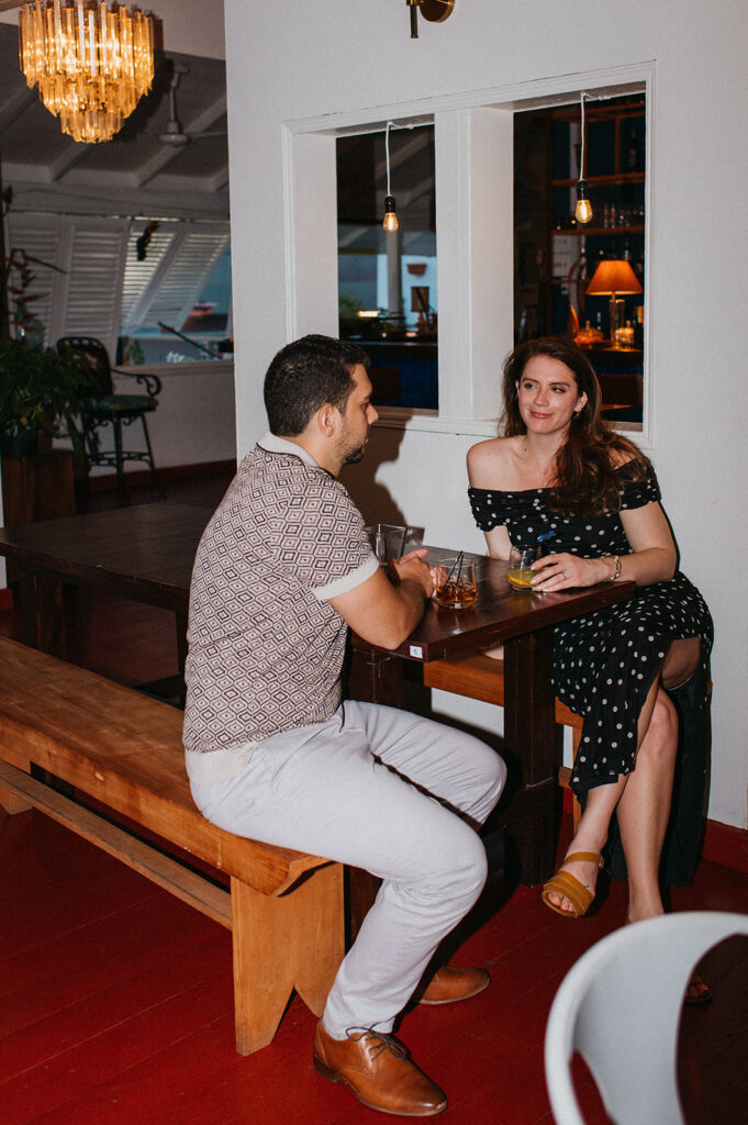 Engagement photo of a couple laughing together on a night out
