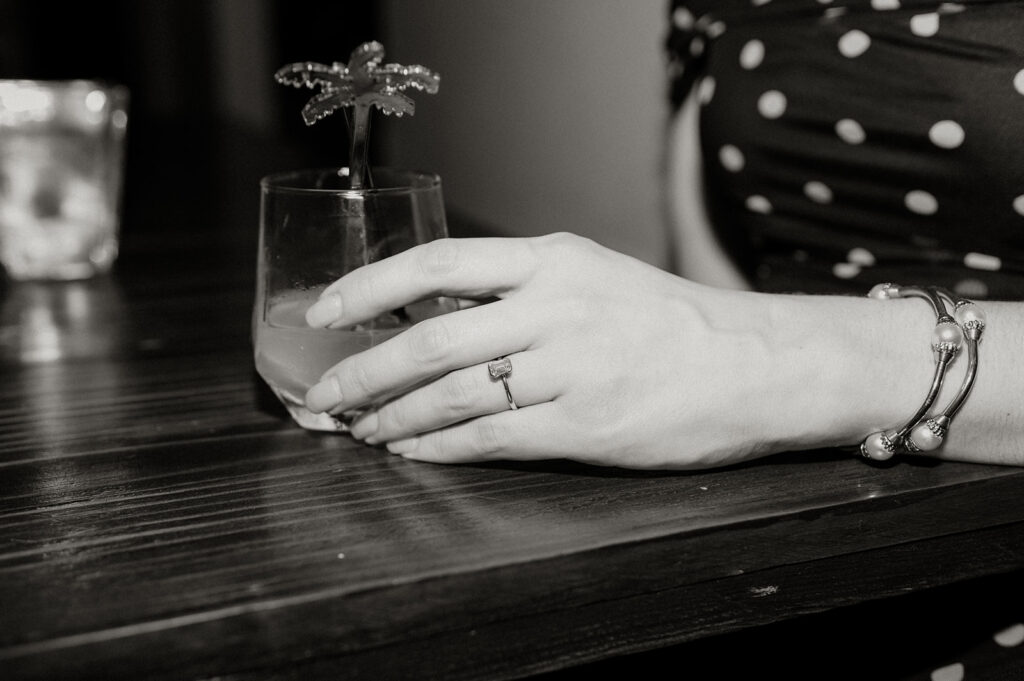 Couple enjoying cocktails together during their engagement session on Ariapita Avenue
