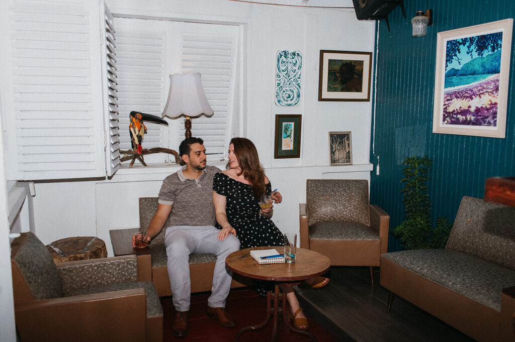 Engagement photo of a couple laughing together on a night out
