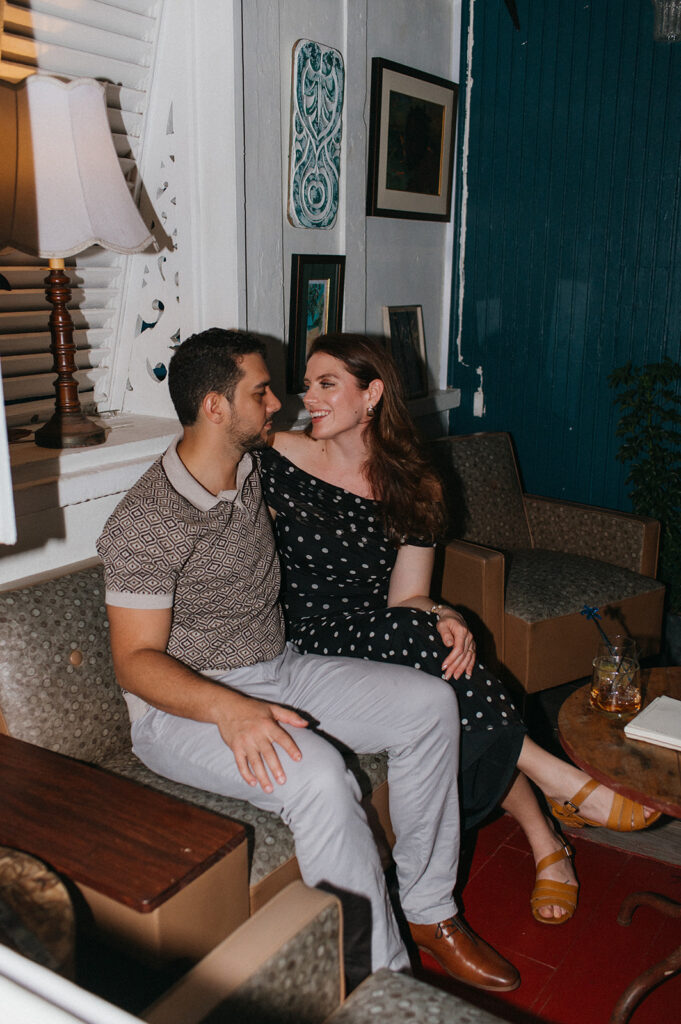 Engagement photo of a couple laughing together on a night out
