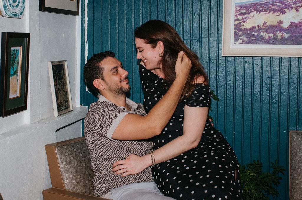 Engagement photo of a couple laughing together on a night out
