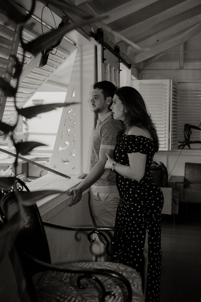 Couple enjoying cocktails together during their engagement session on Ariapita Avenue
