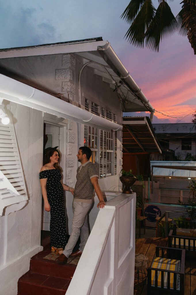 Couple enjoying cocktails together during their engagement session on Ariapita Avenue
