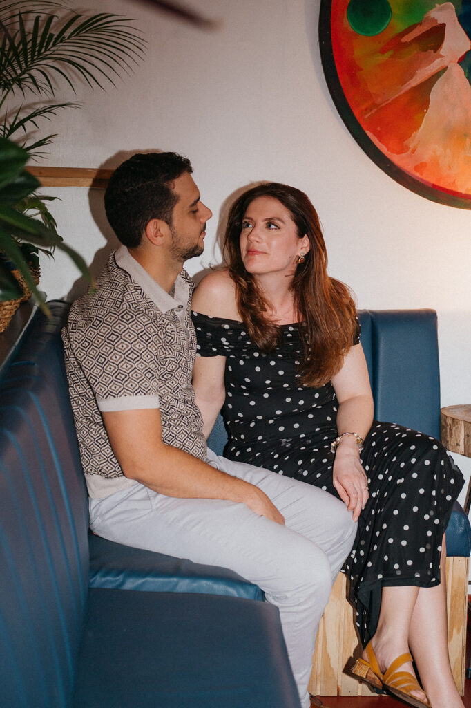 Couple enjoying cocktails together during their engagement session on Ariapita Avenue
