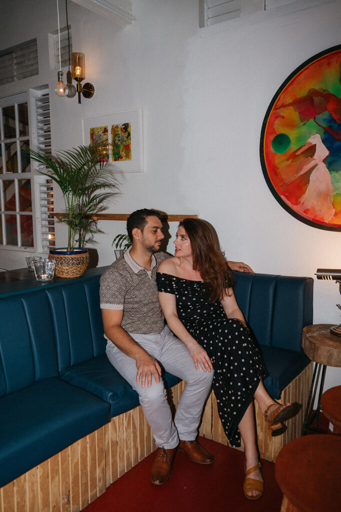 Couple enjoying cocktails together during their engagement session on Ariapita Avenue

