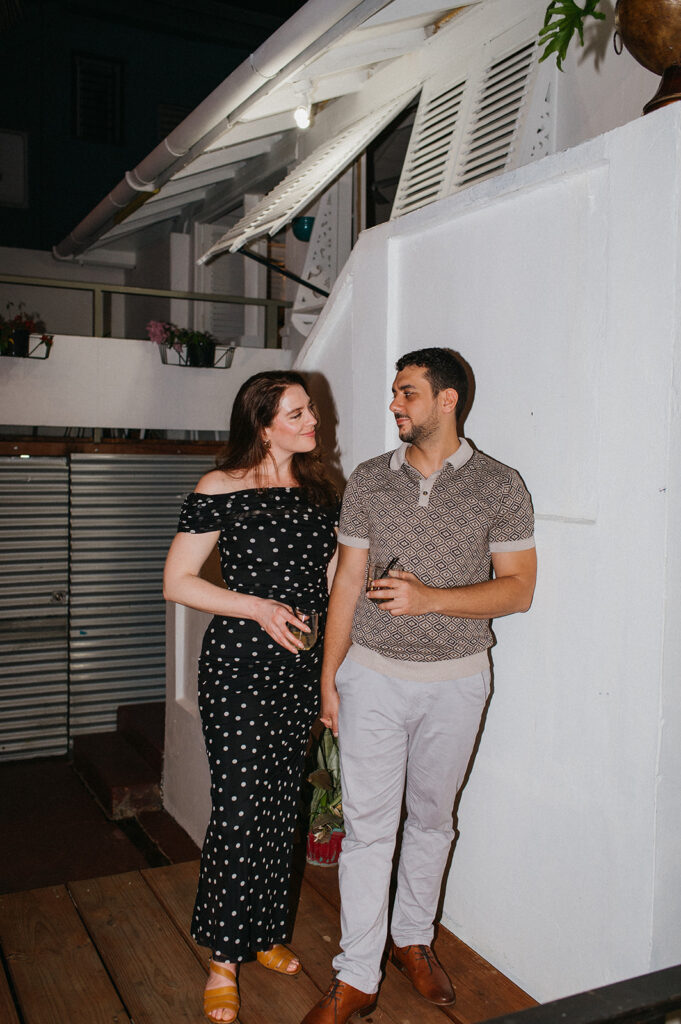 Couple enjoying cocktails together during their engagement session on Ariapita Avenue
