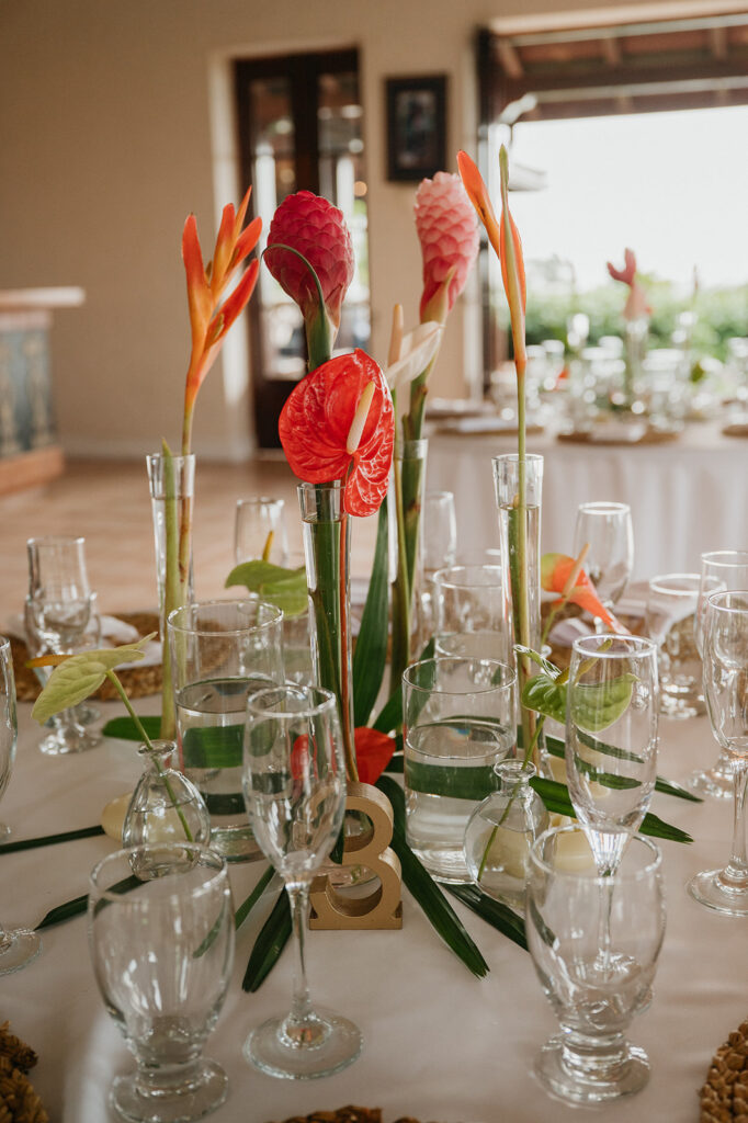Close-up of tropical wedding floral arrangements with light colors
