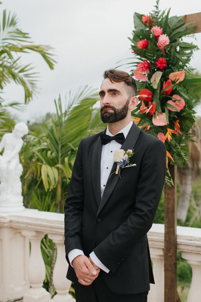 Intimate wedding ceremony with family and friends gathered outdoors
