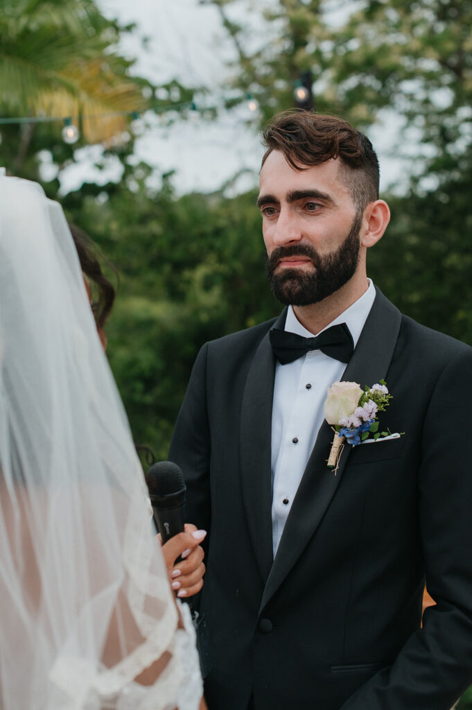 Intimate wedding ceremony with family and friends gathered outdoors

