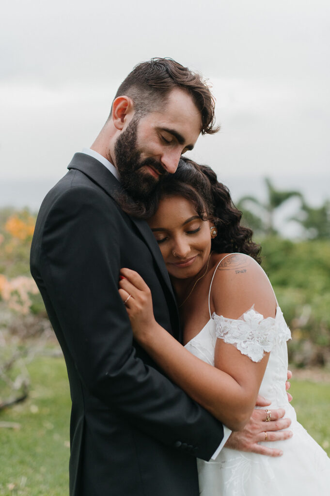 Bride and groom sharing a romantic moment during their outdoor wedding - The villas at Stone Haven
