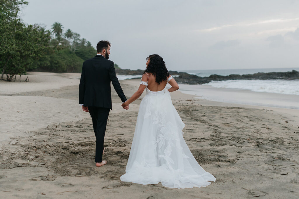 Couple walking barefoot on the beach at sunset
 - The villas at Stone Haven