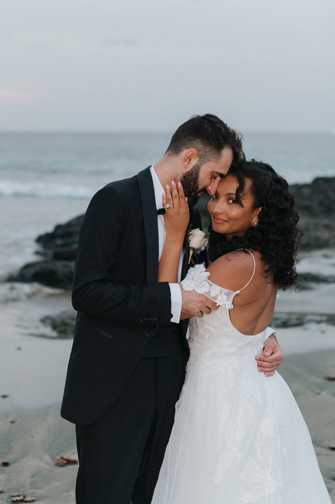 Bride and groom sharing a romantic moment during their outdoor wedding - The villas at Stone Haven
