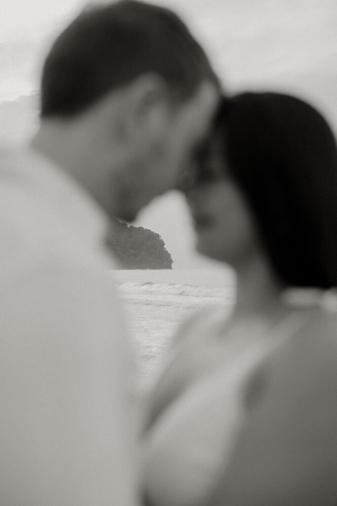 Playful engagement moment as Ross twirls Andrea in the empty stretch of beach during golden hour.
