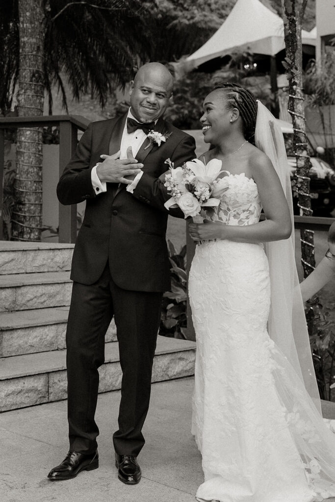 Romantic outdoor wedding ceremony surrounded by greenery.
