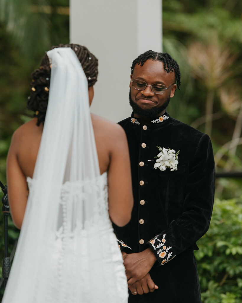 Romantic outdoor wedding ceremony surrounded by greenery.
