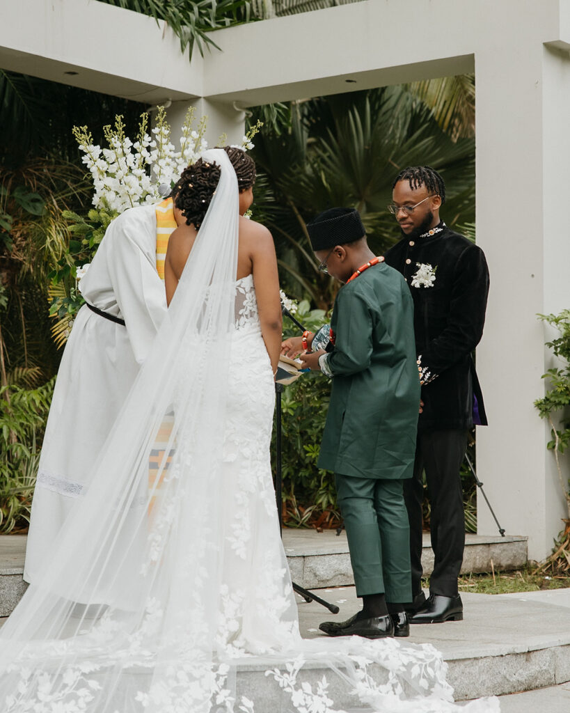 Romantic outdoor wedding ceremony surrounded by greenery.
