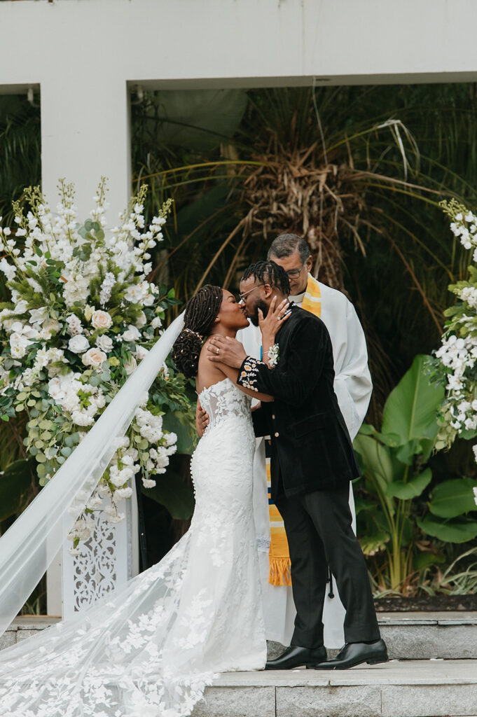 Romantic outdoor wedding ceremony surrounded by greenery.
