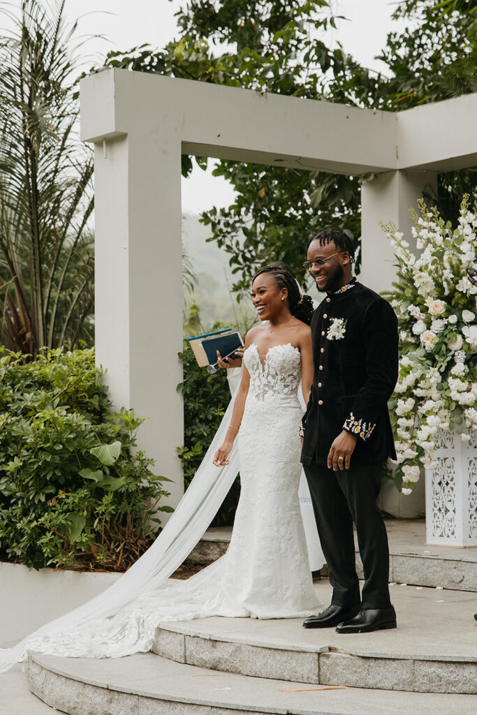 Romantic outdoor wedding ceremony surrounded by greenery.
