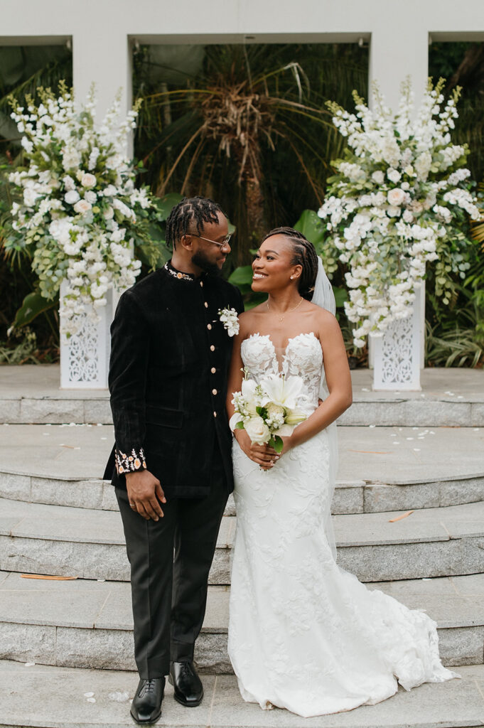 Couple walking hand in hand during portraits in the lush grounds.

