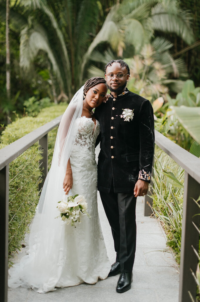Couple walking hand in hand during portraits in the lush grounds.
