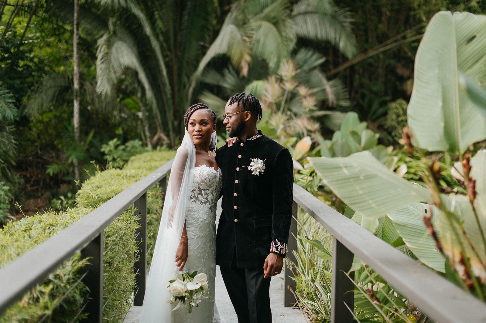 Bride and groom sharing a candid moment in the gardens of Estate 101, Trinidad.