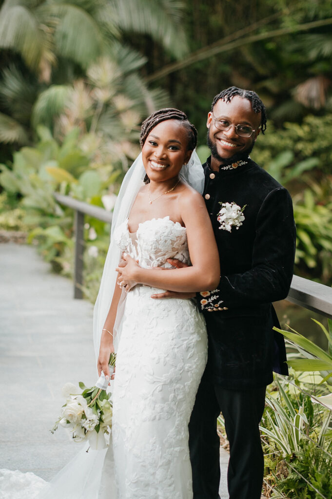 Couple walking hand in hand during portraits in the lush grounds.
