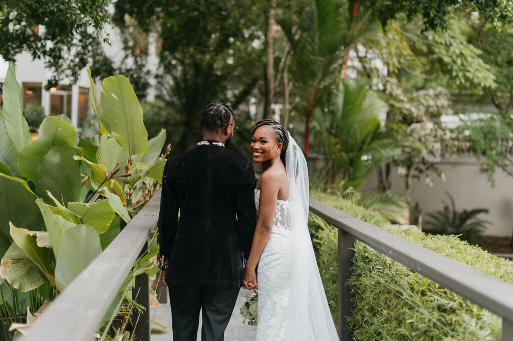 Elegant wedding portraits taken with tropical garden backdrops.
