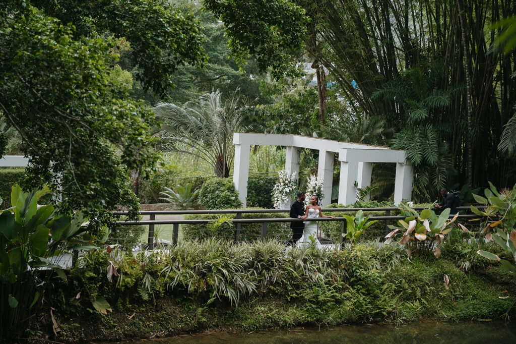 Elegant wedding portraits taken with tropical garden backdrops.

