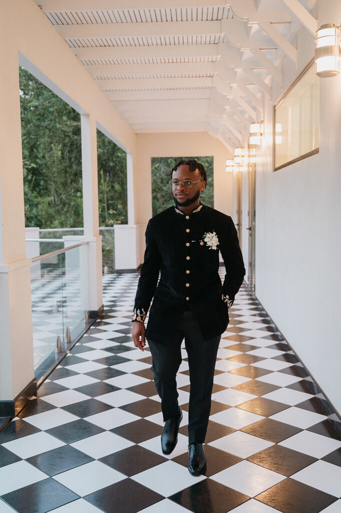 Groom walking to his estate 101 wedding reception