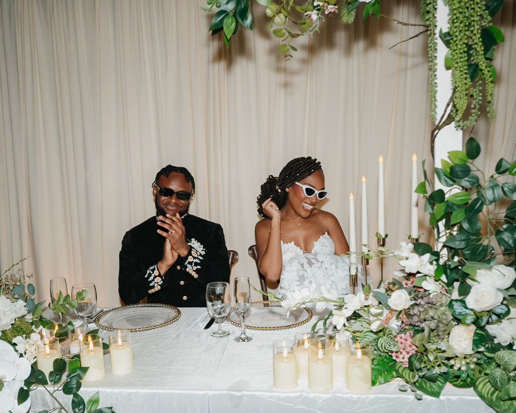 Candid laughter and joy captured during a wedding toast at Estate 101.