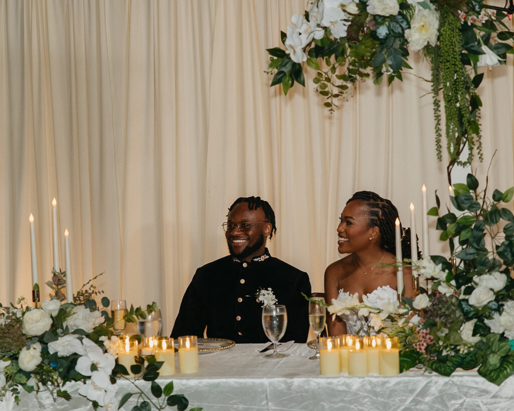 Candid laughter and joy captured during a wedding toast at Estate 101.