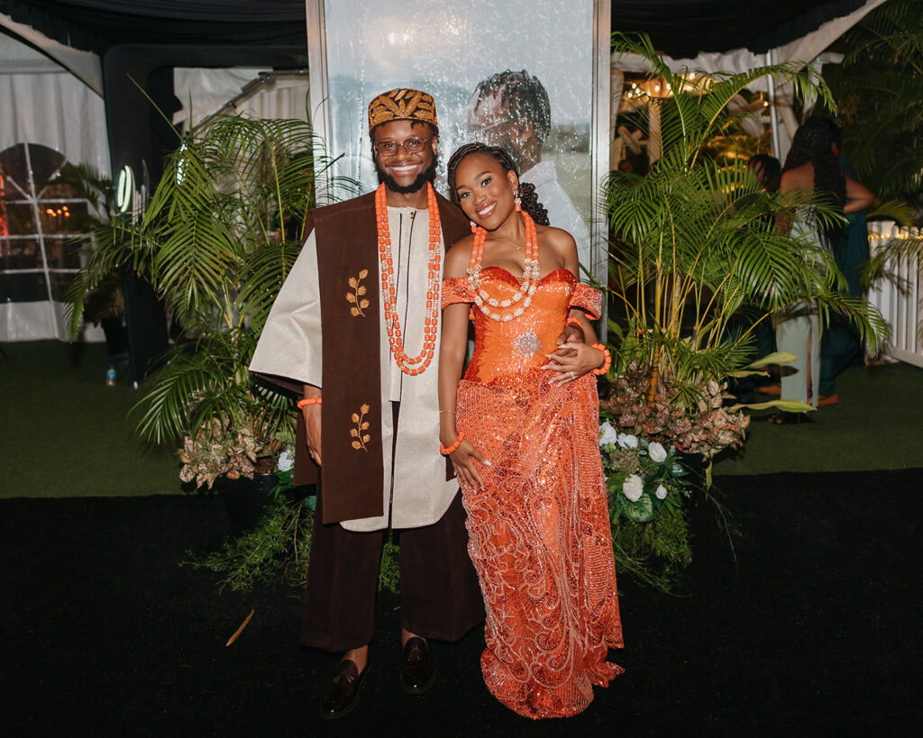 Bride and groom in traditional Nigerian attire dancing.
